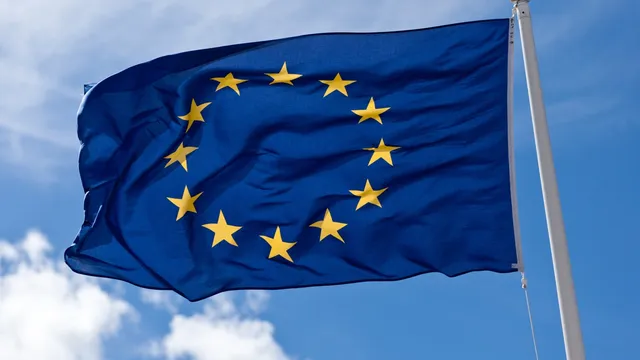 Close-up of the European Union flag, with gold stars on a blue field, symbolising the EU AI Act's pan-European scope.