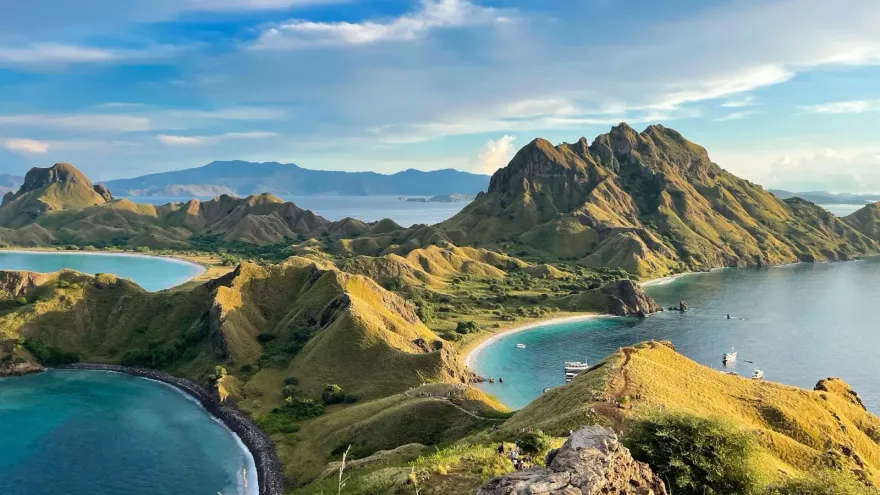 Aerial view of green volcanic islands and turquoise bays, a landscape evoking the natural resources GreenPT works to protect.