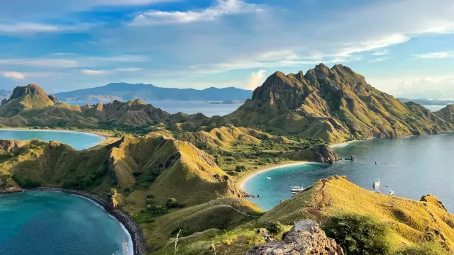 Aerial view of green volcanic islands and turquoise bays, a landscape evoking the natural resources GreenPT works to protect.